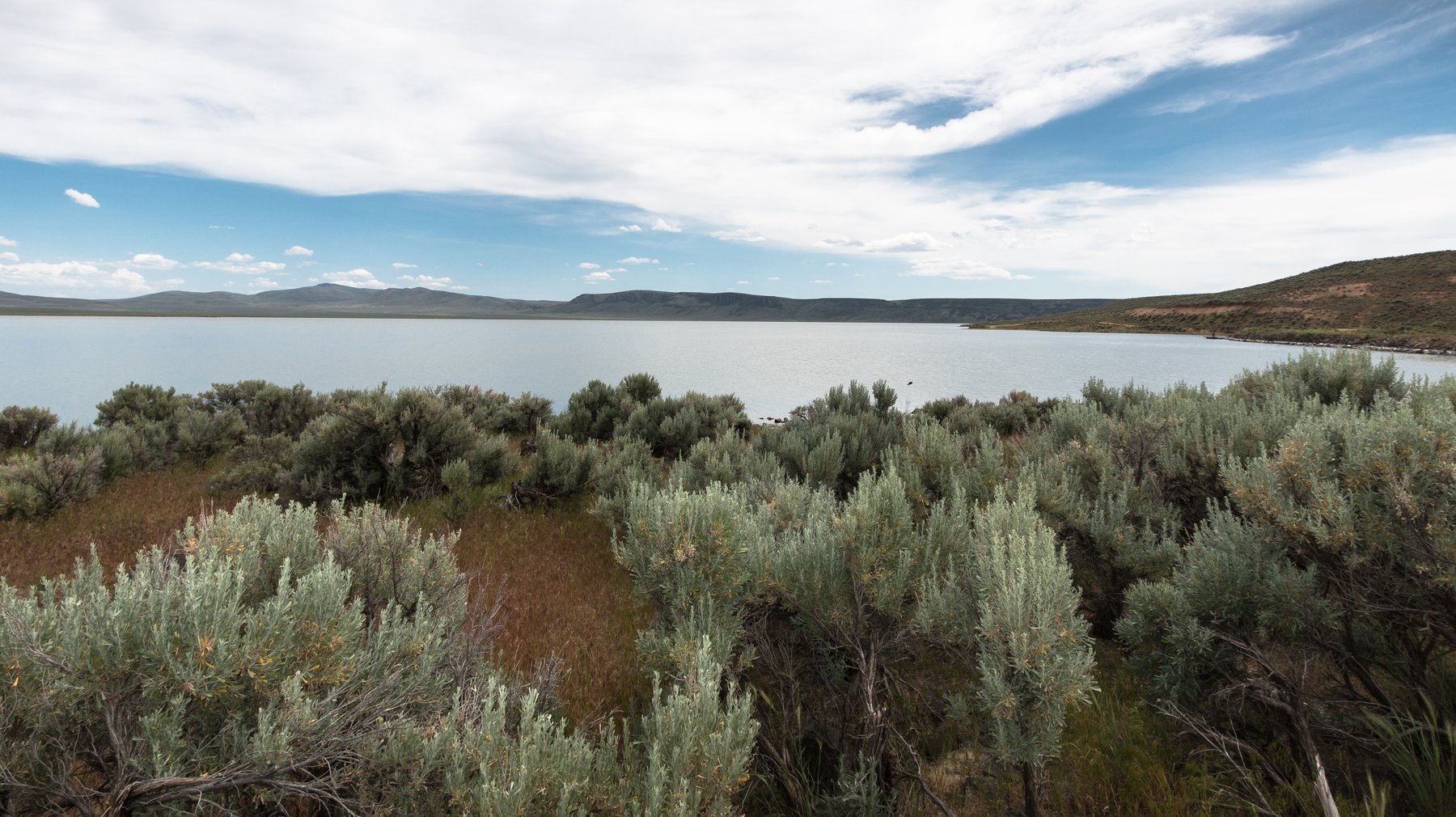 Antelope Reservoir seen from a sagebrush-lined campsite, looking southeast toward Juniper Ridge