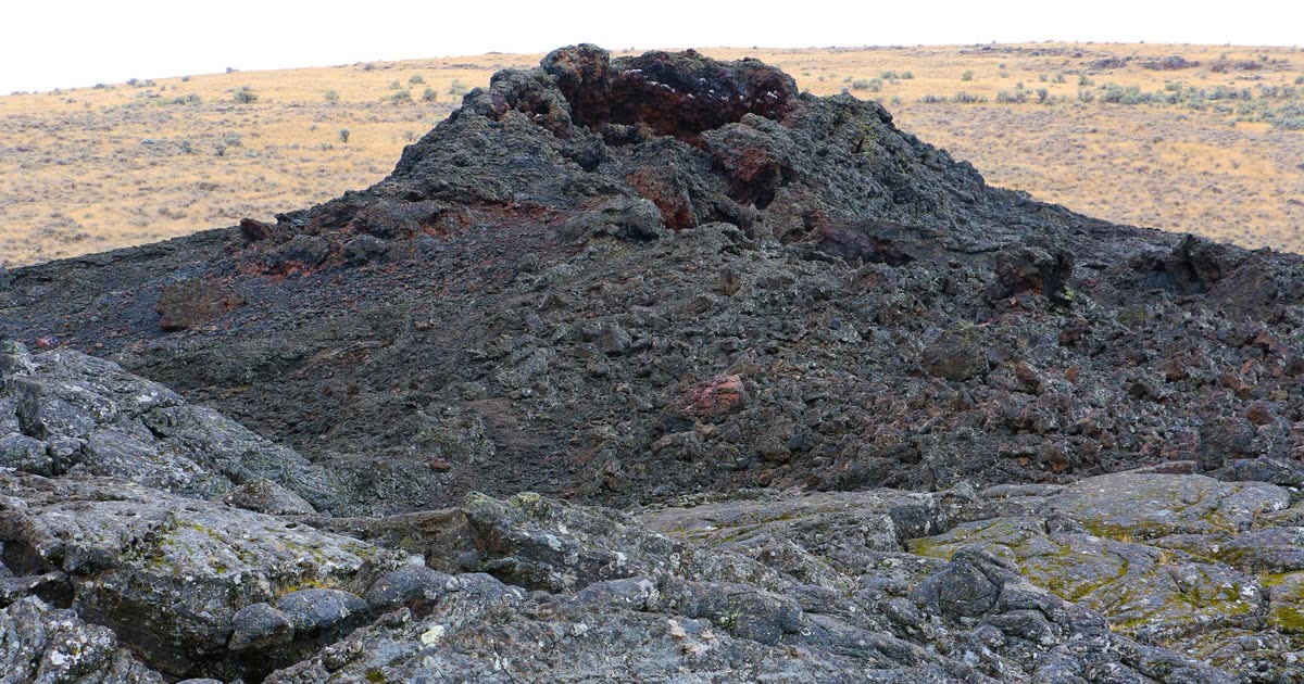 The steep-sided Coffeepot Crater at Jordan Craters, a deep volcanic cavity in the black lava field