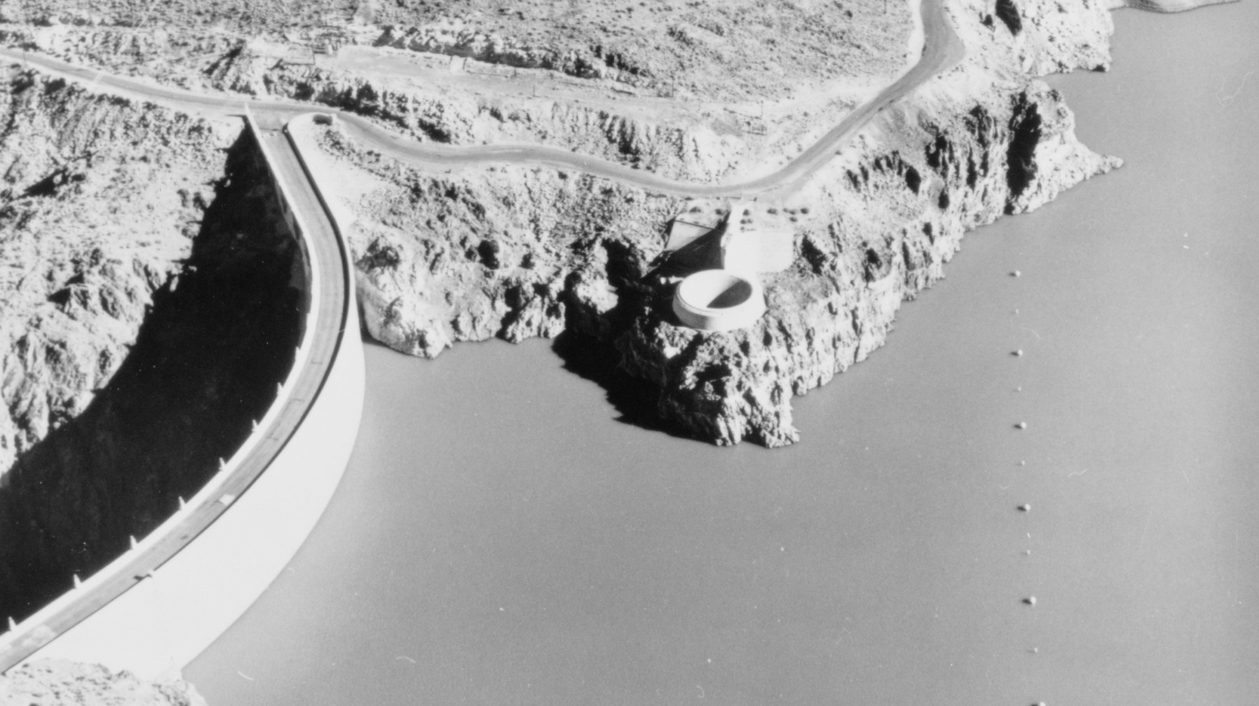 Aerial view of Owyhee Dam and its ring-gate spillway holding back Lake Owyhee